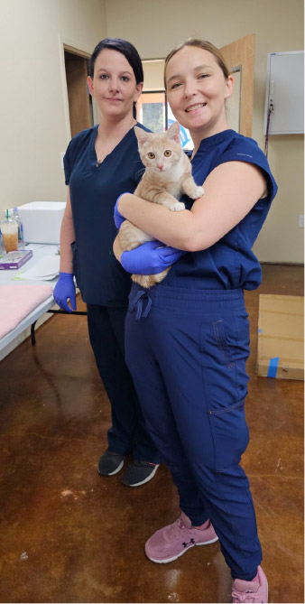 Clinic staff with a cat.